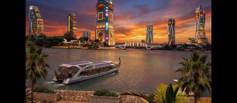 A solar ferry crossing Mombasa harbour at dusk, with the city's future skyline behind it